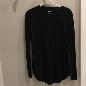 U neck. Black long sleeve.  Three dots